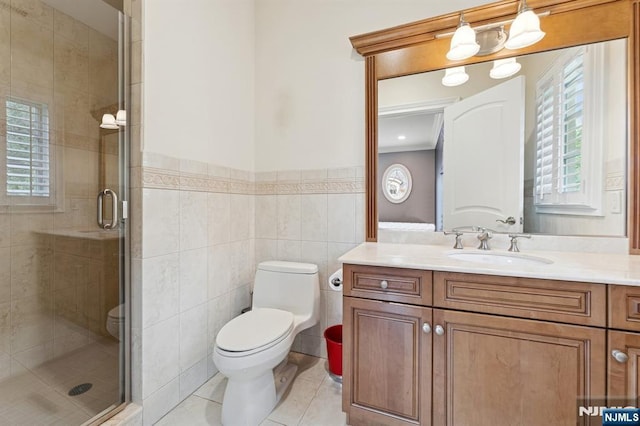 511 Bellaire Dr, Demarest, NJ 07627 - bathroom featuring toilet, vanity, a stall shower, tile patterned flooring, and tile walls