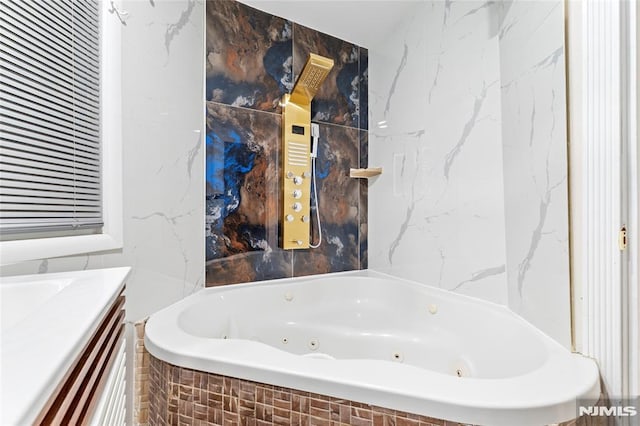 99 W 50th St, Bayonne, NJ 07002 - bathroom featuring tile walls, a jetted tub, and vanity