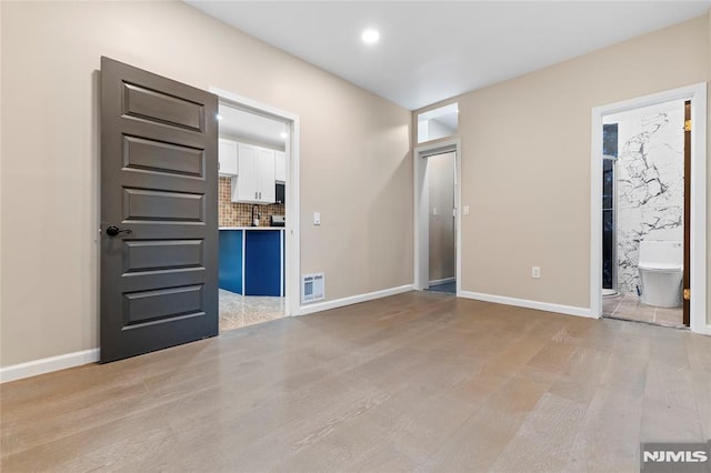 99 W 50th St, Bayonne, NJ 07002 - unfurnished bedroom featuring light wood-style flooring, recessed lighting, baseboards, and ensuite bath