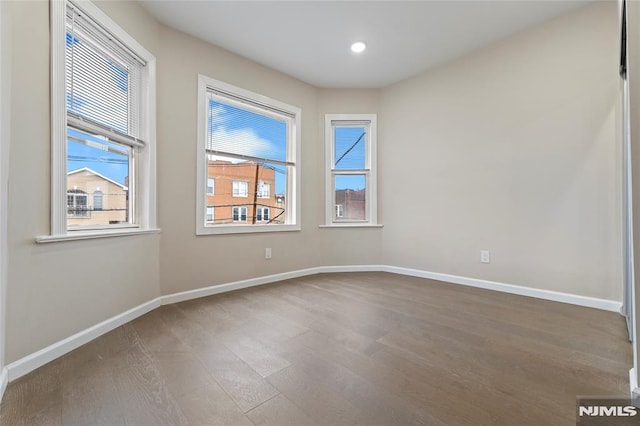 99 W 50th St, Bayonne, NJ 07002 - unfurnished room featuring wood finished floors, baseboards, and recessed lighting