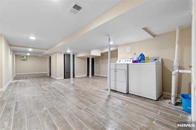 99 W 50th St, Bayonne, NJ 07002 - finished basement with washing machine and clothes dryer, light wood finished floors, baseboards, and recessed lighting