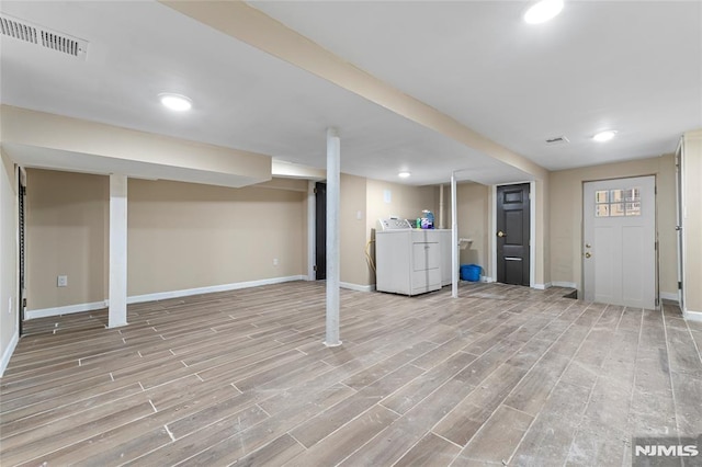99 W 50th St, Bayonne, NJ 07002 - finished below grade area with washing machine and dryer, baseboards, light wood finished floors, and recessed lighting