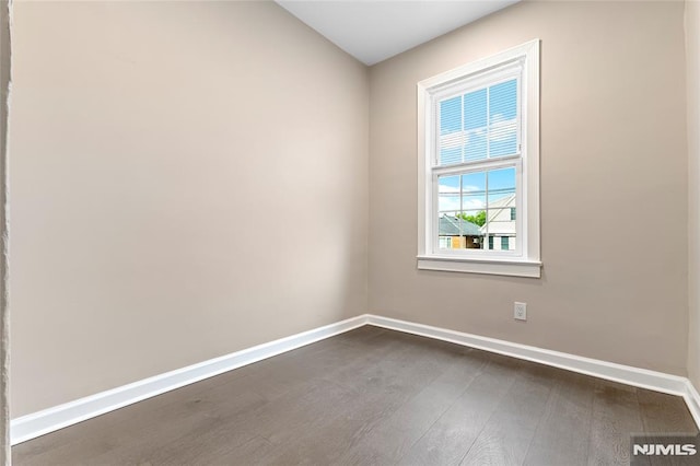 99 W 50th St, Bayonne, NJ 07002 - empty room featuring dark wood finished floors and baseboards