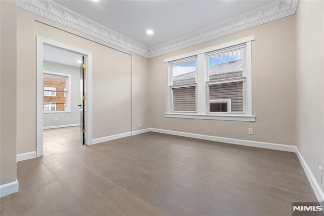 99 W 50th St, Bayonne, NJ 07002 - unfurnished room featuring wood finished floors, plenty of natural light, baseboards, ornamental molding, and recessed lighting