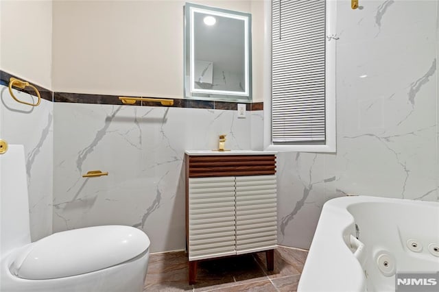 99 W 50th St, Bayonne, NJ 07002 - full bathroom with tile walls, a jetted tub, and toilet