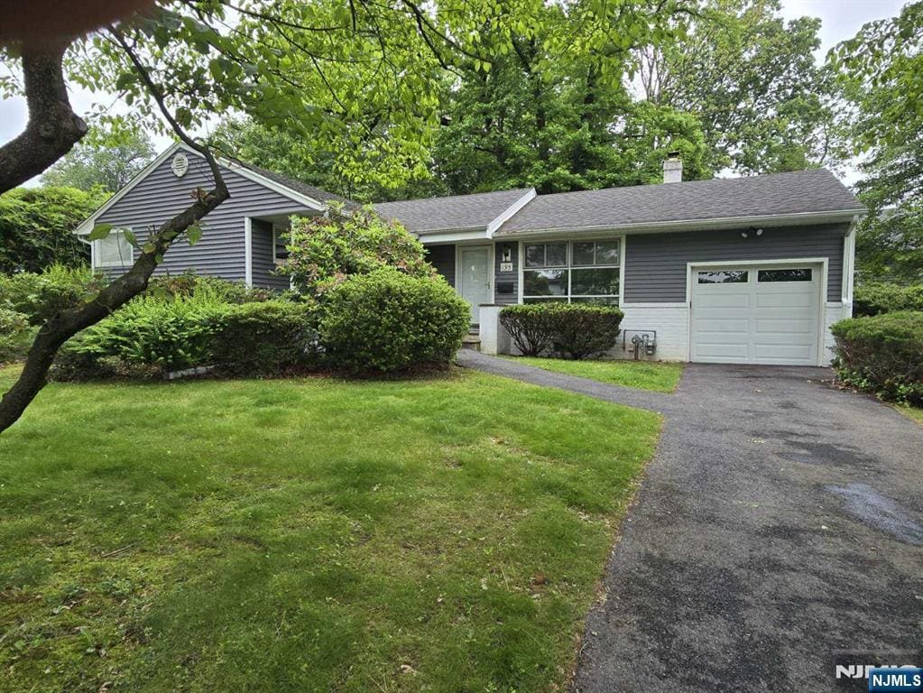 195 Concord Dr, Paramus, NJ 07652 - ranch-style home featuring an attached garage, a front lawn, asphalt driveway, and a chimney