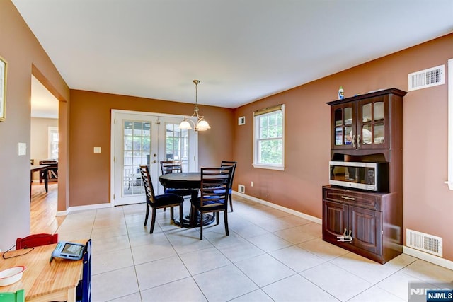 25 Fern Ter, Wayne, NJ 07470 - dining area featuring a chandelier, baseboards, and light tile patterned flooring