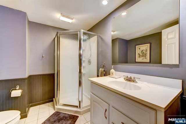 25 Fern Ter, Wayne, NJ 07470 - full bath with vanity, a stall shower, toilet, tile patterned floors, and wainscoting