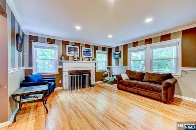 25 Fern Ter, Wayne, NJ 07470 - living room with crown molding, wood finished floors, a brick fireplace, baseboards, and recessed lighting