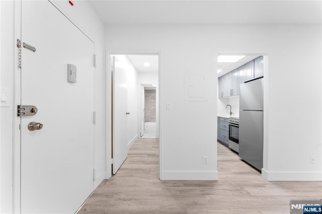 1111 River Rd Unit F25, Edgewater, NJ 07020 - hall with baseboards, light wood-type flooring, and a sink