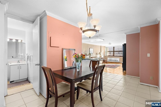 7004JFKB 70th Unit 40G, Guttenberg, NJ 07093 - dining space with crown molding, light tile patterned floors, a chandelier, and baseboards