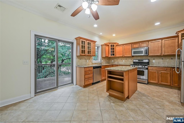 445B 7th St Unit B, Palisades Park, NJ 07650 - kitchen featuring appliances with stainless steel finishes, open shelves, brown cabinets, tasteful backsplash, and crown molding