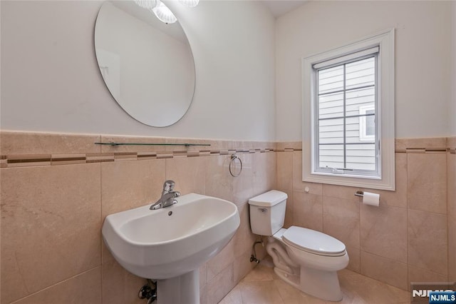 445B 7th St Unit B, Palisades Park, NJ 07650 - bathroom featuring wainscoting, tile patterned flooring, and tile walls