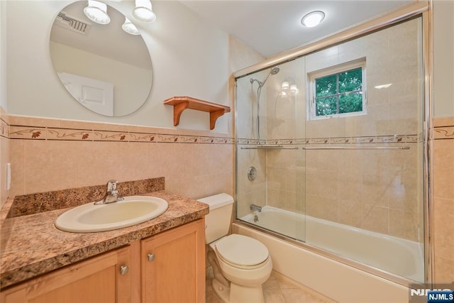 445B 7th St Unit B, Palisades Park, NJ 07650 - bathroom with tile walls, vanity, bath / shower combo with glass door, wainscoting, and tile patterned floors