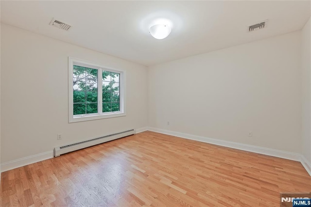 445B 7th St Unit B, Palisades Park, NJ 07650 - unfurnished room featuring a baseboard radiator and light wood-type flooring