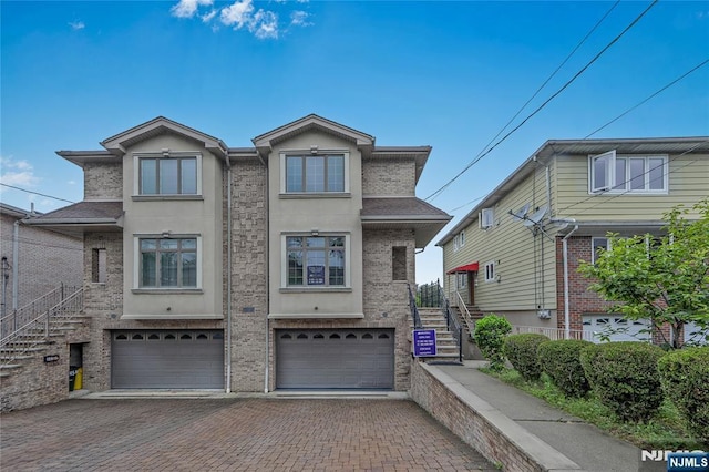 445B 7th St Unit B, Palisades Park, NJ 07650 - view of front of property featuring driveway, a garage, and stucco siding