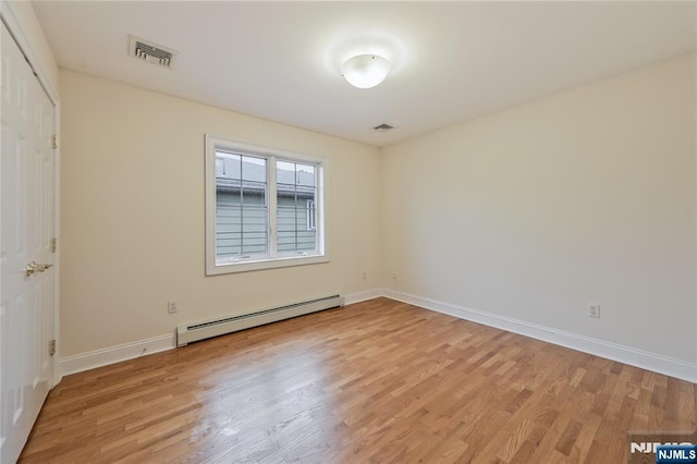 445B 7th St Unit B, Palisades Park, NJ 07650 - unfurnished bedroom featuring a baseboard heating unit and light wood-style floors