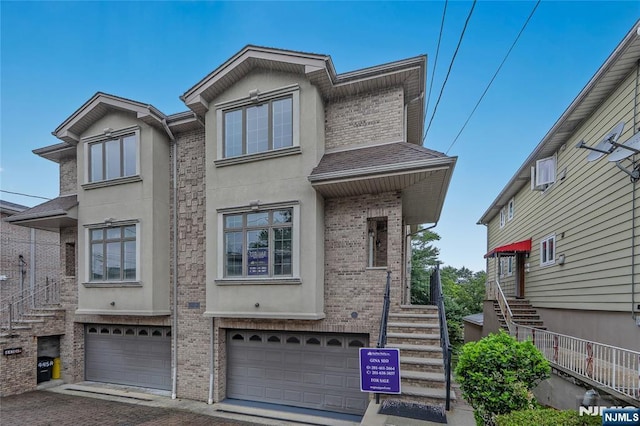 445B 7th St Unit B, Palisades Park, NJ 07650 - multi unit property with stucco siding, an attached garage, brick siding, and stairway
