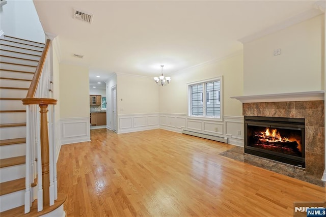 445B 7th St Unit B, Palisades Park, NJ 07650 - unfurnished living room featuring a baseboard heating unit, stairs, ornamental molding, a tiled fireplace, and a chandelier
