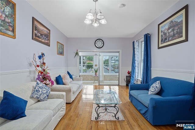 548 Jefferson Ave, Elizabeth, NJ 07201 - living area featuring a chandelier, wainscoting, and wood finished floors