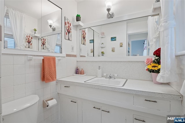 548 Jefferson Ave, Elizabeth, NJ 07201 - bathroom with tile walls, vanity, and toilet