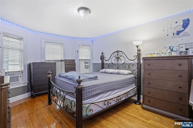 548 Jefferson Ave, Elizabeth, NJ 07201 - bedroom featuring cooling unit, light wood-style floors, multiple windows, and baseboards