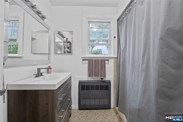 548 Jefferson Ave, Elizabeth, NJ 07201 - bathroom with radiator heating unit, vanity, plenty of natural light, and a shower with curtain