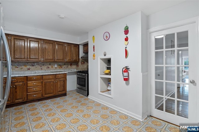 548 Jefferson Ave, Elizabeth, NJ 07201 - kitchen featuring stainless steel appliances, decorative backsplash, and light floors