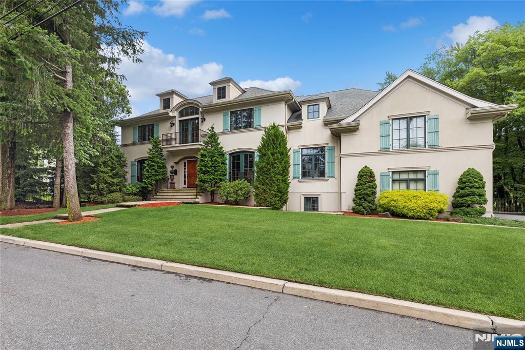 44 Central Ave, Demarest, NJ 07627 - view of front facade featuring stucco siding, a front yard, and a balcony
