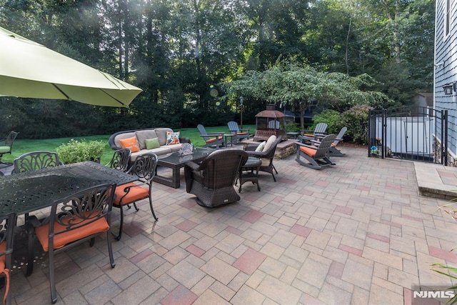 87 Skytop Dr, Mahwah, NJ 07430 - view of patio / terrace featuring outdoor dining area, an outdoor living space with a fire pit, view of wooded area, and a gate