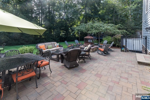 87 Skytop Dr, Mahwah, NJ 07430 - view of patio / terrace with outdoor dining space, an outdoor living space with a fire pit, view of wooded area, and a gate