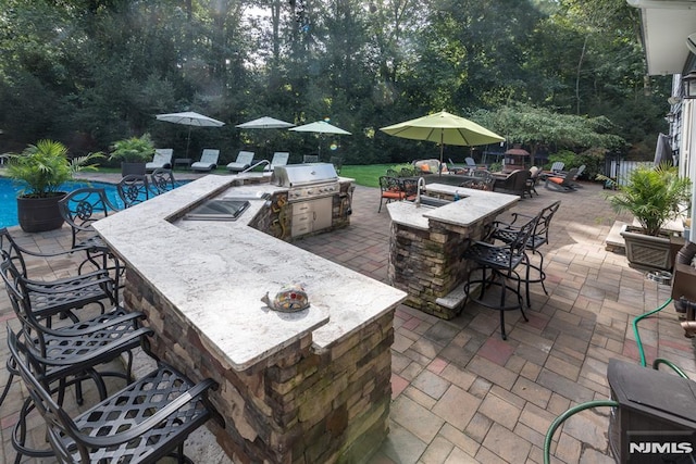 87 Skytop Dr, Mahwah, NJ 07430 - view of patio with exterior kitchen and view of scattered trees