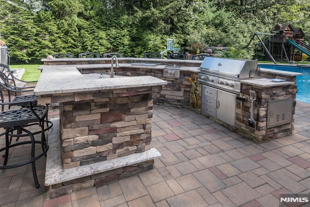 87 Skytop Dr, Mahwah, NJ 07430 - view of patio / terrace featuring exterior kitchen and a playground