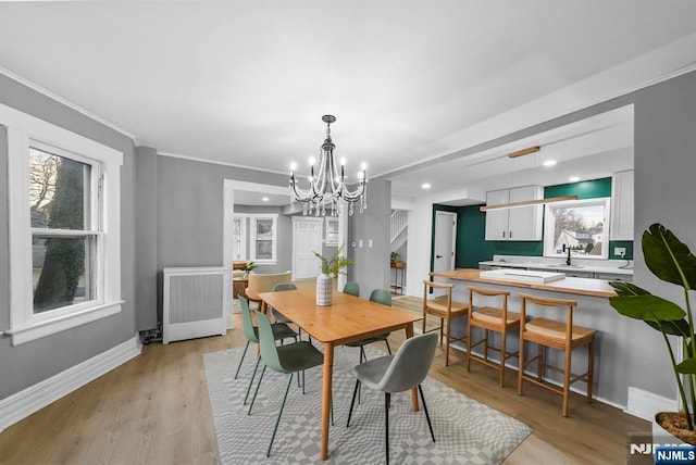 518 Bloomfield Ave, Nutley, NJ 07110 - dining space featuring a chandelier, radiator, healthy amount of natural light, baseboards, and ornamental molding