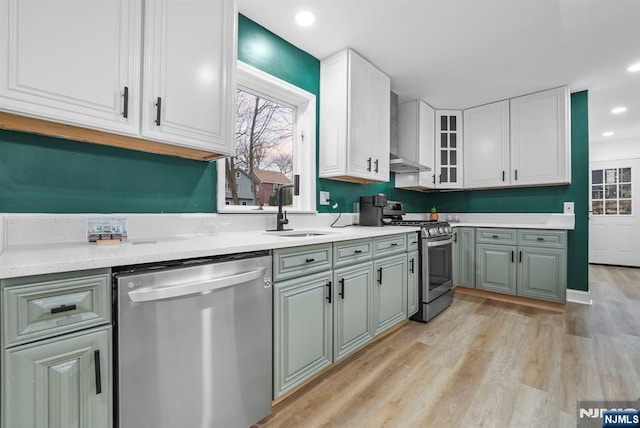 518 Bloomfield Ave, Nutley, NJ 07110 - kitchen featuring stainless steel appliances, a sink, light wood-style flooring, white cabinets, and light countertops