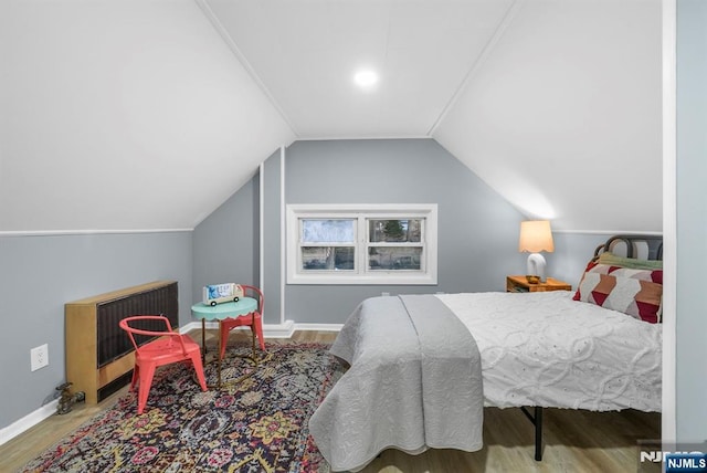 518 Bloomfield Ave, Nutley, NJ 07110 - bedroom featuring wood finished floors, vaulted ceiling, baseboards, and heating unit