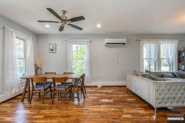 129 Phelps Ave, Englewood, NJ 07631 - dining room featuring an AC wall unit, wood finished floors, ceiling fan, baseboards, and recessed lighting