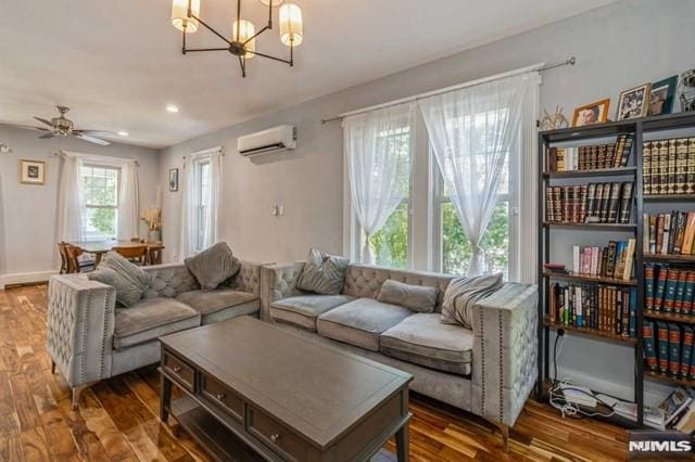129 Phelps Ave, Englewood, NJ 07631 - living room featuring a wall mounted AC, a chandelier, wood finished floors, and a ceiling fan