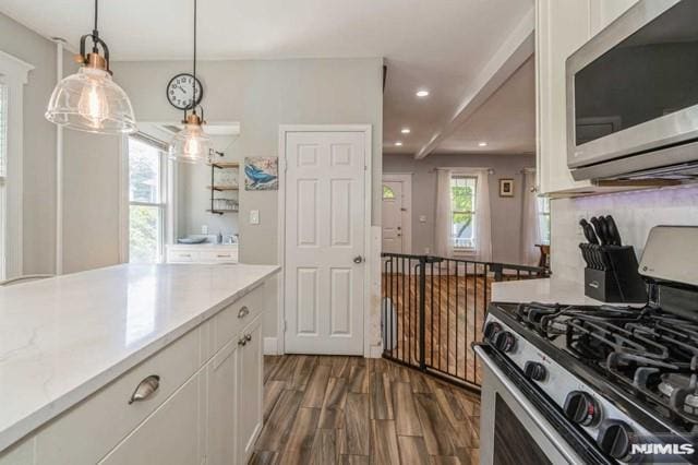 129 Phelps Ave, Englewood, NJ 07631 - kitchen featuring stainless steel appliances, dark wood-type flooring, white cabinetry, light countertops, and recessed lighting
