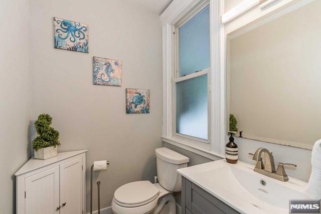 129 Phelps Ave, Englewood, NJ 07631 - half bath featuring toilet and vanity