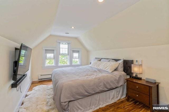 129 Phelps Ave, Englewood, NJ 07631 - bedroom with a baseboard heating unit, lofted ceiling, wood finished floors, and recessed lighting