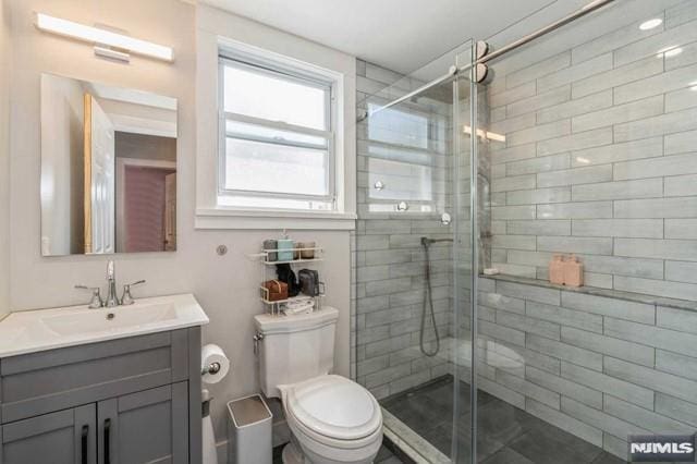 129 Phelps Ave, Englewood, NJ 07631 - bathroom featuring vanity, toilet, and a stall shower