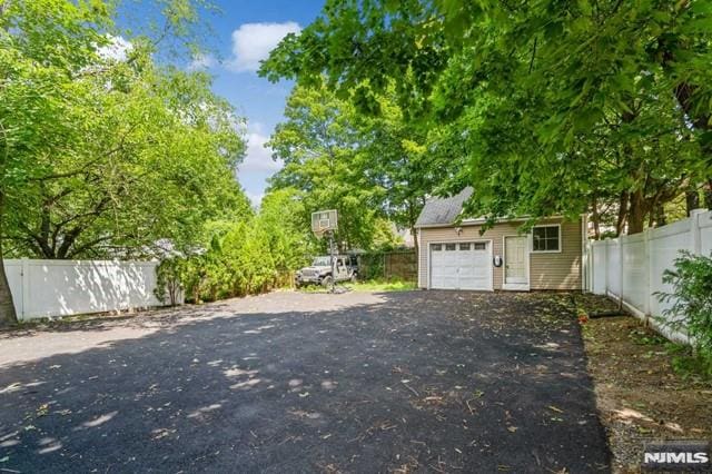 129 Phelps Ave, Englewood, NJ 07631 - view of yard featuring an outbuilding, a garage, and driveway