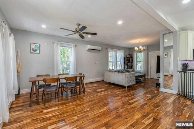 129 Phelps Ave, Englewood, NJ 07631 - dining space with wood finished floors, an AC wall unit, a chandelier, baseboards, and recessed lighting