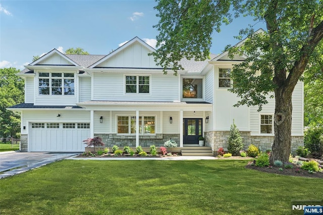 107 Rutland Rd, Glen Rock, NJ 07452 - view of front of home with stone siding, concrete driveway, and an attached garage