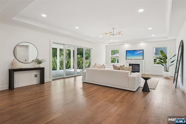 107 Rutland Rd, Glen Rock, NJ 07452 - living room with a raised ceiling, wood finished floors, a high end fireplace, a chandelier, and baseboards