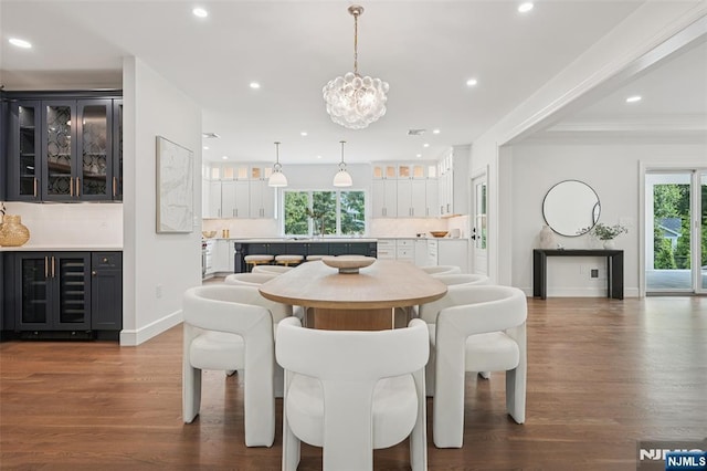 107 Rutland Rd, Glen Rock, NJ 07452 - dining area featuring beverage cooler, healthy amount of natural light, dark wood-style floors, recessed lighting, and a chandelier