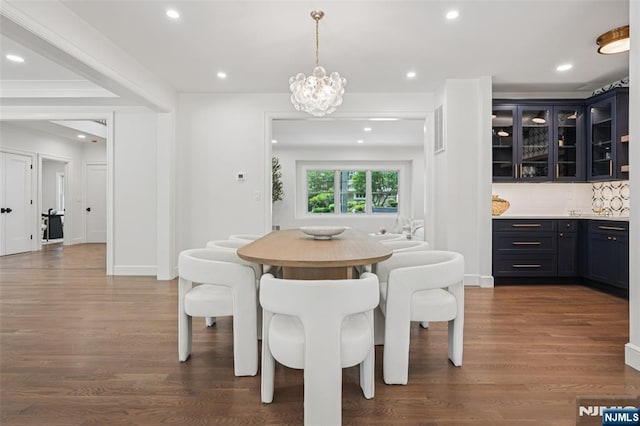 107 Rutland Rd, Glen Rock, NJ 07452 - dining space featuring dark wood finished floors, recessed lighting, a chandelier, bar, and baseboards