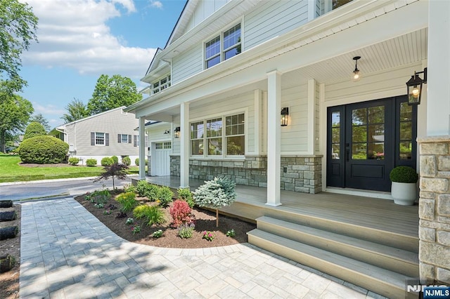 107 Rutland Rd, Glen Rock, NJ 07452 - property entrance with a porch, stone siding, and board and batten siding