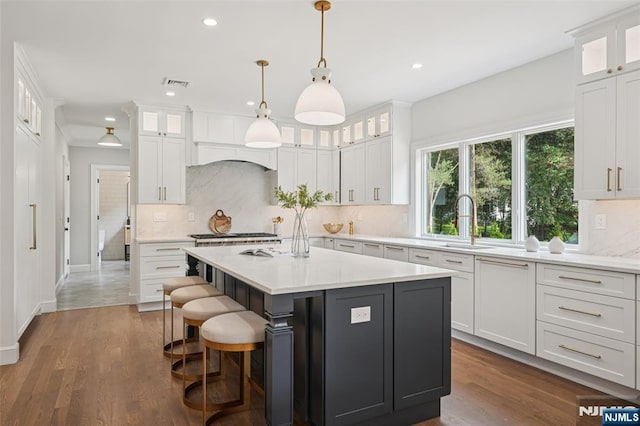 107 Rutland Rd, Glen Rock, NJ 07452 - kitchen featuring a sink, light countertops, recessed lighting, a kitchen island, and backsplash
